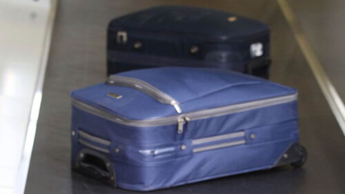 Two suitcases on a belt conveyor.